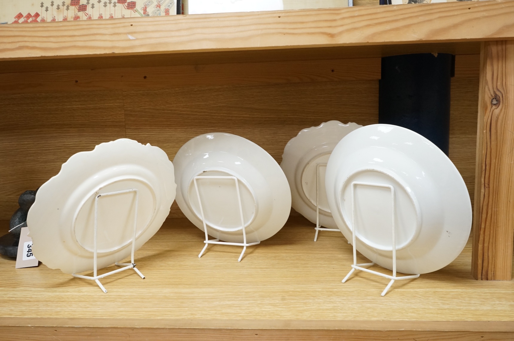 Two pairs of early 19th century porcelain botanical dishes, largest 22cm in diameter